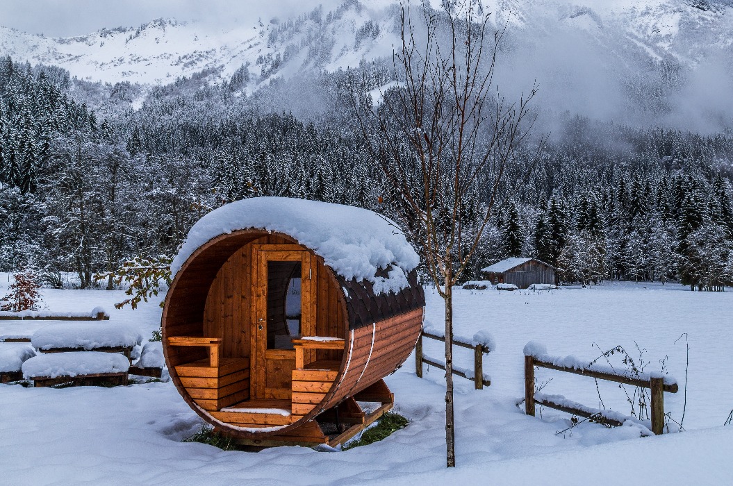 Holzsauna in einer verschneiten Landschaft