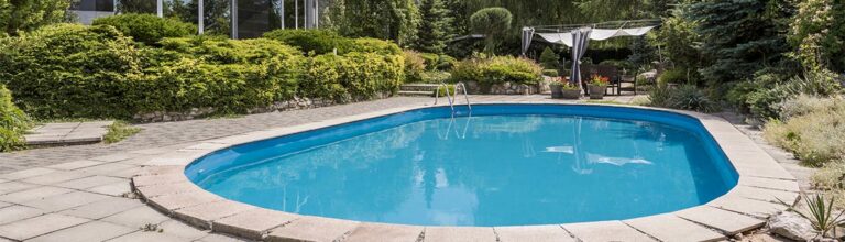 Oval swimming pool in big garden